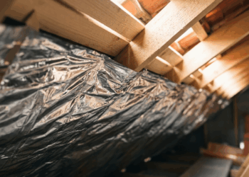 A barreira radiante escondida sob o telhado que parece papel-alumínio de obra, mas foi criada para refletir o calor antes que ele invada o forro da casa