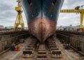 Um gigantesco estaleiro utiliza docas secas, guindastes monumentais e plataformas móveis para construir navios entre os maiores do planeta